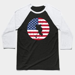 American Flag and Ice Hockey Player Silhouette, A silhouette of an ice hockey player overlaid on a distressed American flag, encapsulating patriotism and sportsmanship. Baseball T-Shirt